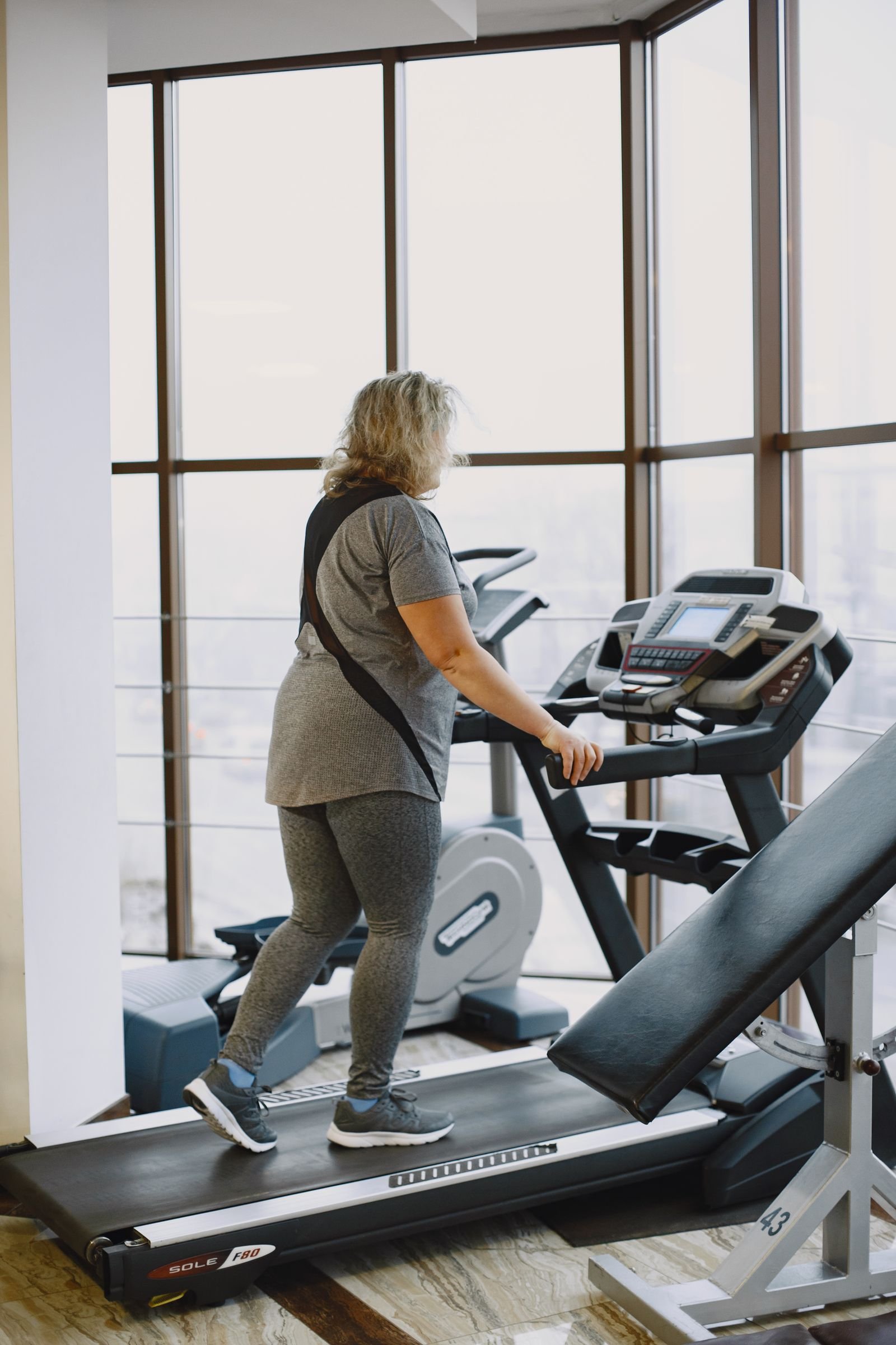 Woman walking on a treadmill indoors for the japanese walking method