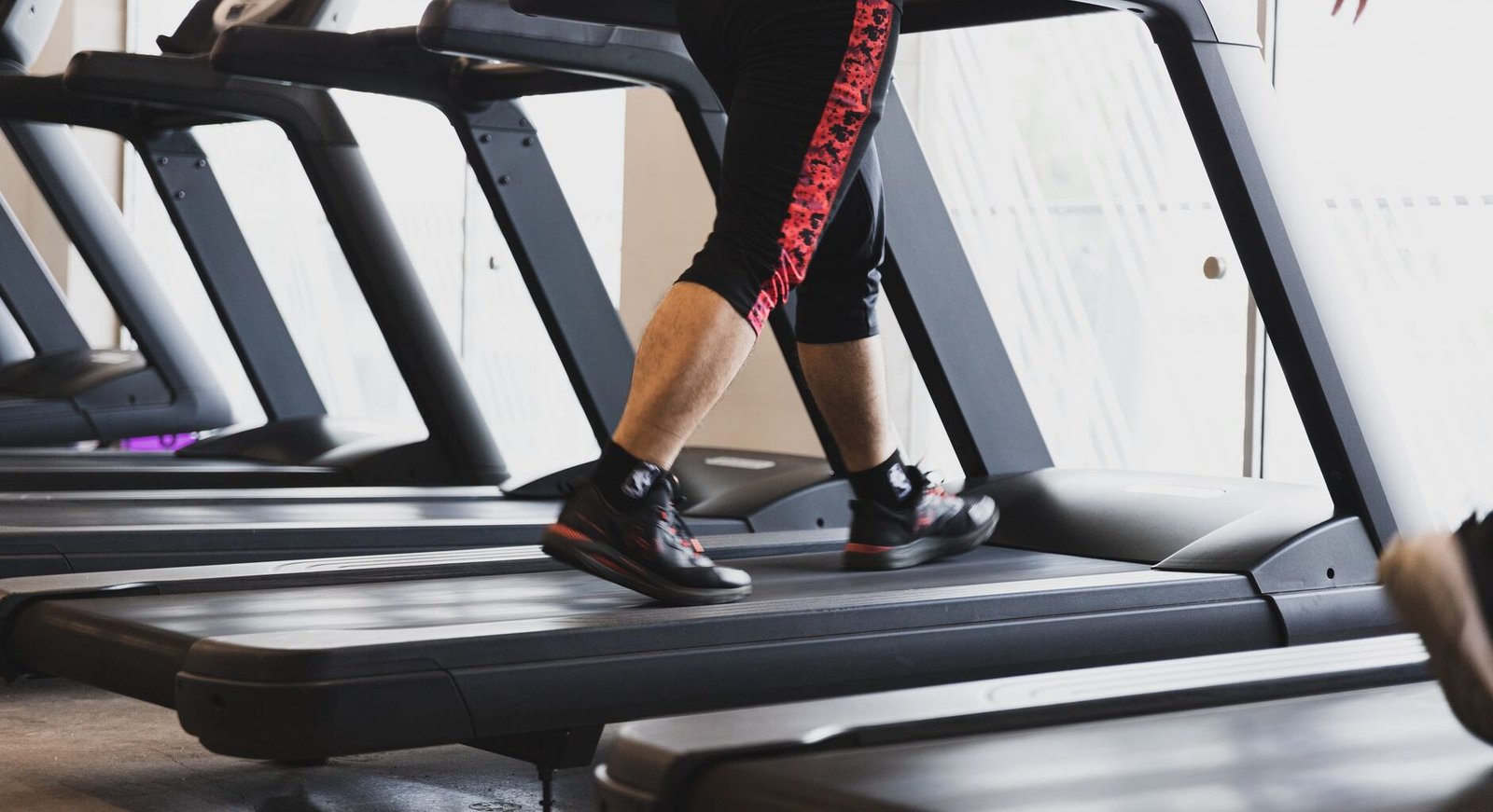 12-3-30 treadmill workout: person walking on an inclined treadmill at the gym