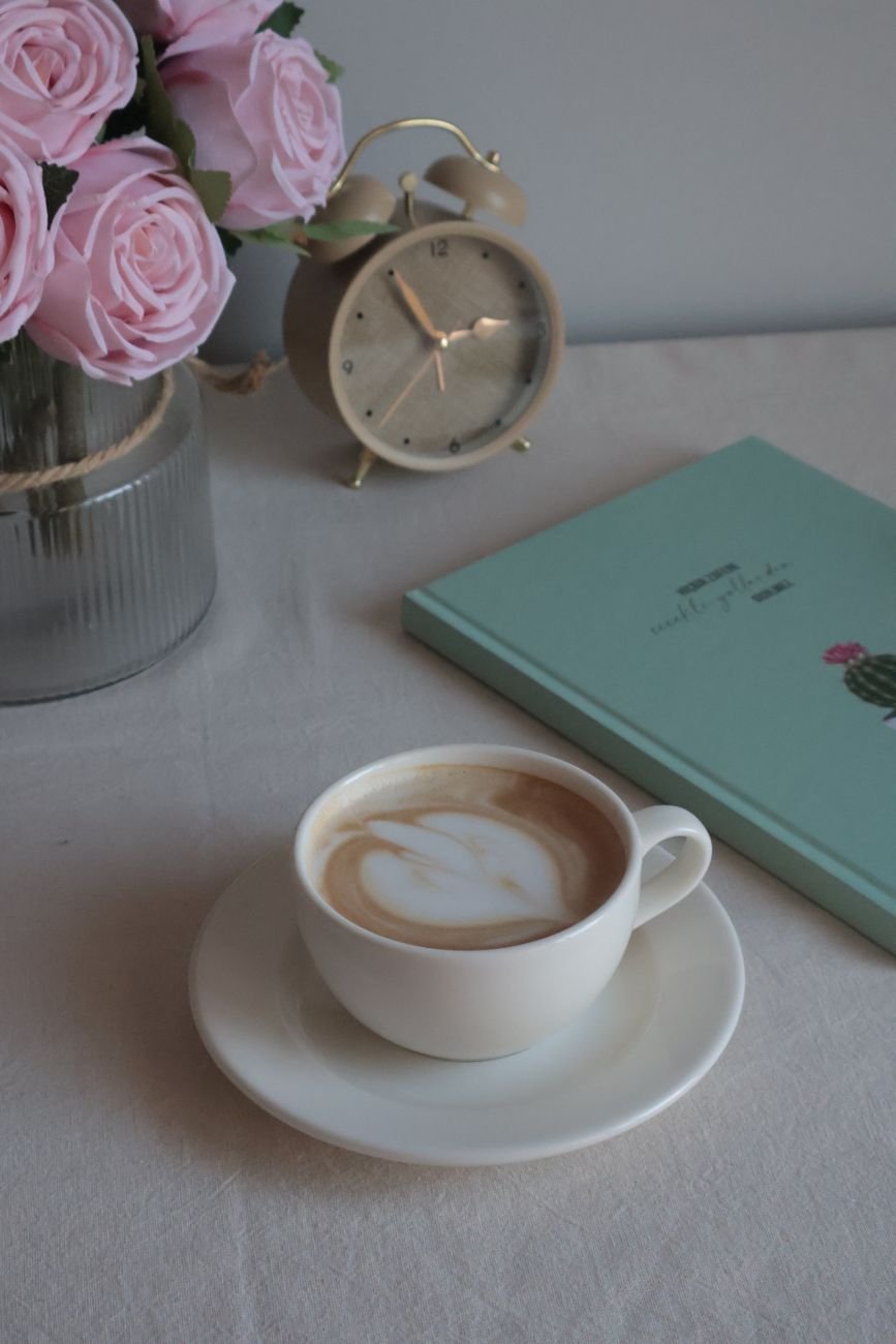 Winter arc early morning routine with alarm clock, journal, and coffee